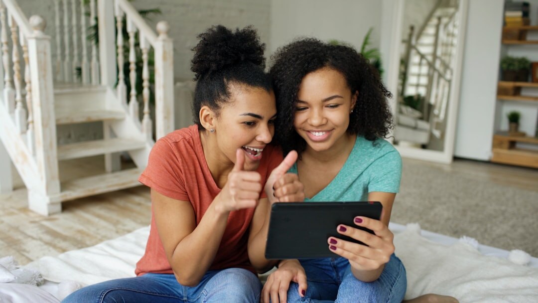 Adult daughter and senior mother looking at a tablet together