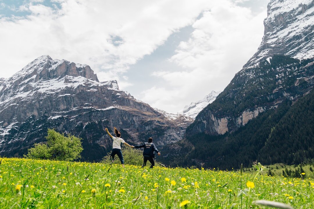 Diverse group of active seniors laughing together outdoors in the Swiss mountains