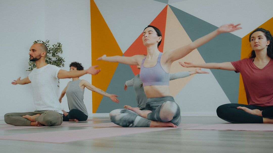 Group of seniors practicing yoga together in a bright studio